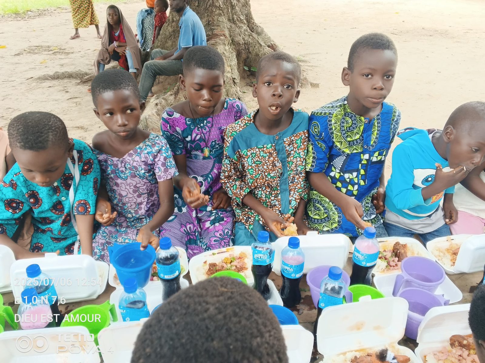 Bambini in abiti colorati davanti al pranzo della festa